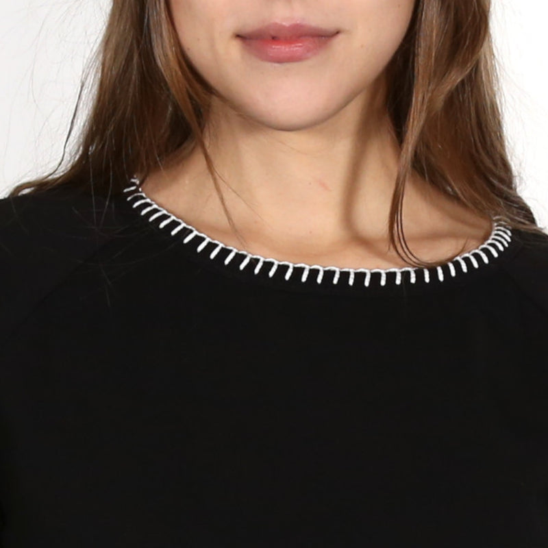 Close up on a woman wearing a black nautical themed crew neck T Shirt