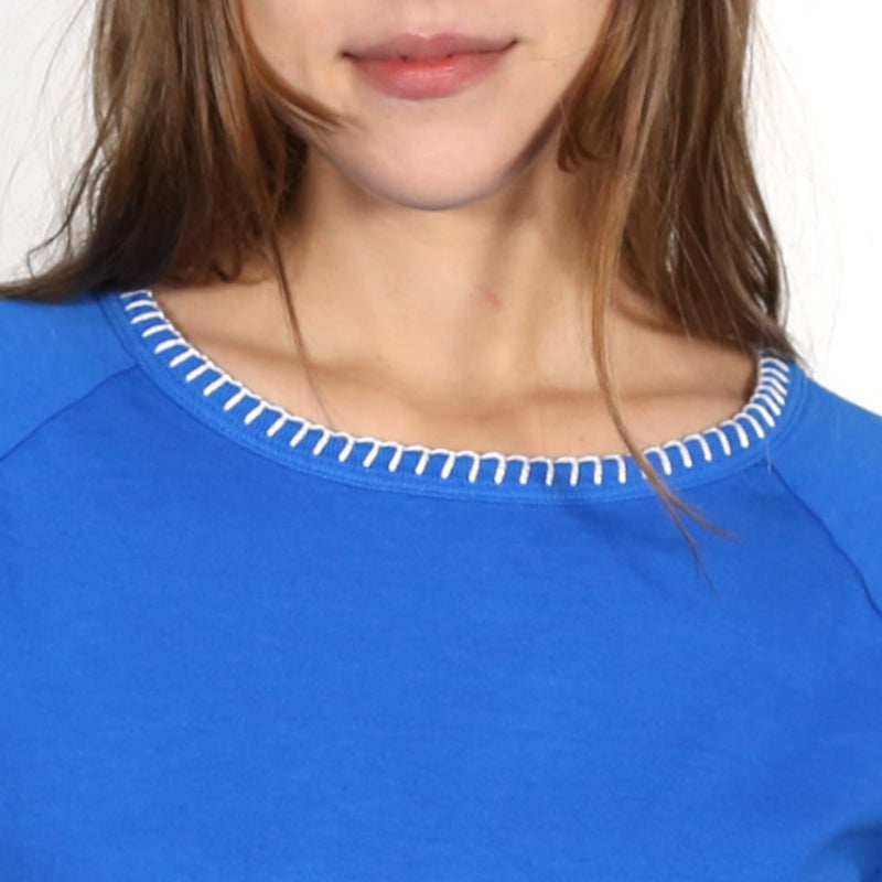 Close up of a woman wearing a blue nautical themed crew neck T Shirt 