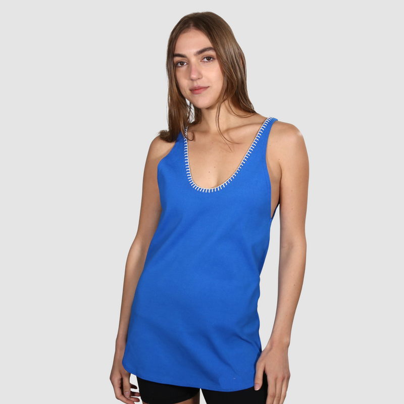 Woman wearing a blue nautical themed tank topon a white background