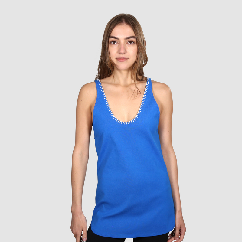 Woman wearing a blue nautical themed tank top on a white background