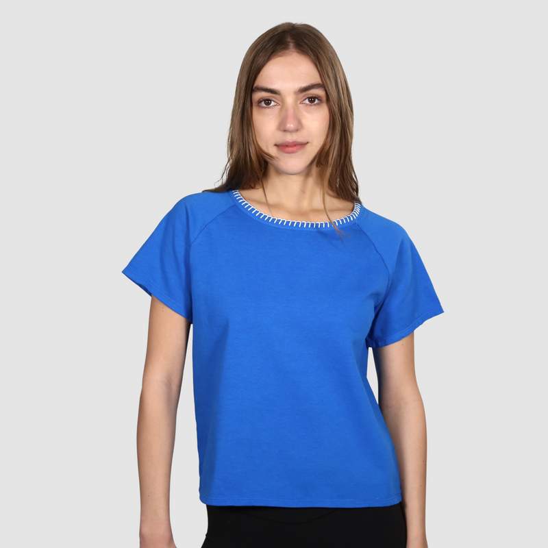 Woman wearing a blue nautical themed crew neck T Shirt on a white background