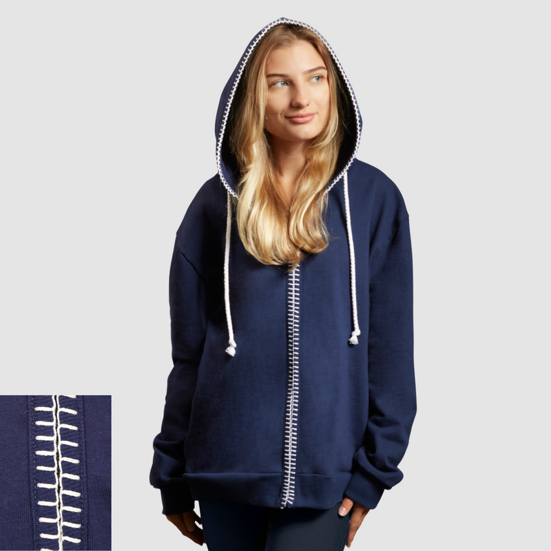 Woman wearing a blue zip up nautical themed hoodie on a white background