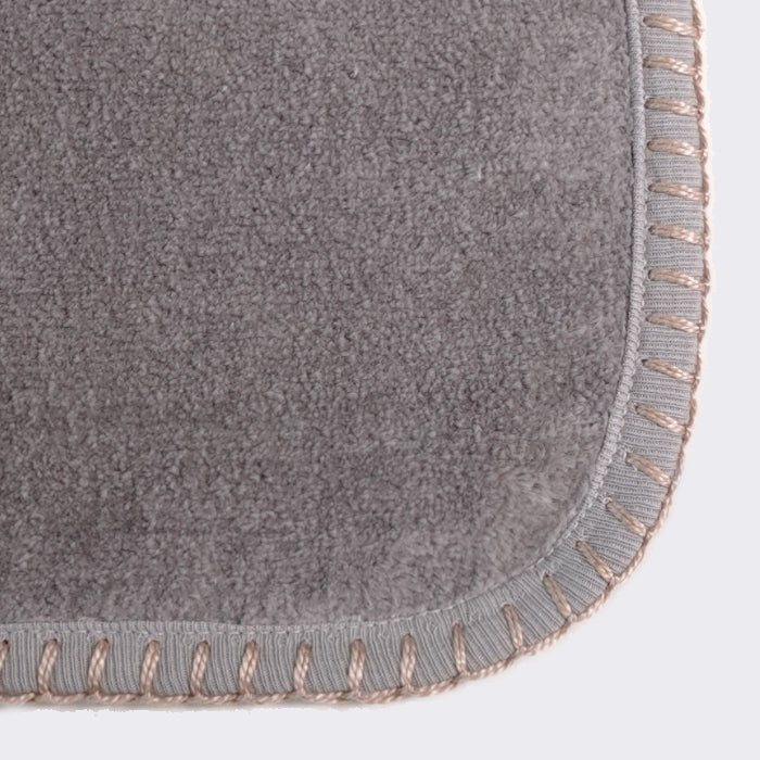 Close up of corner of a towel. Century Silver towel with desert sand color edge stiting.
