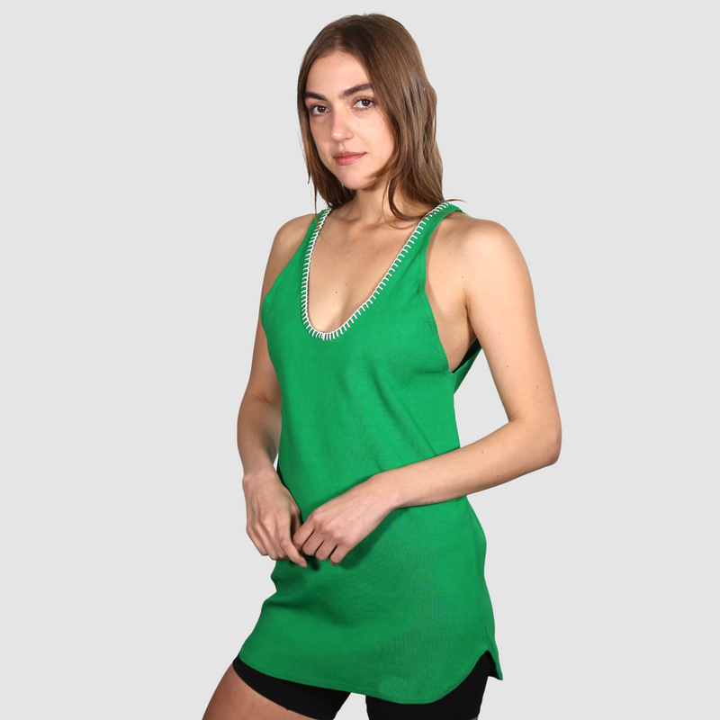 Woman wearing a green nautical themed tank top on a white background
