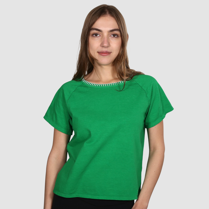 Woman wearing a green nautical themed crew neck T Shirt on a white background