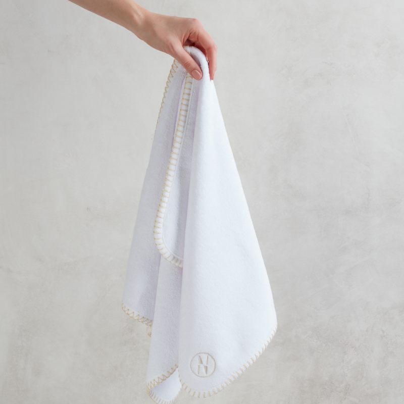 White nautical themed hand towel hanging from women&