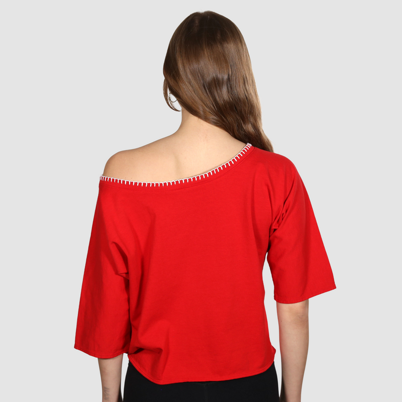 Woman facing back to camera wearing a red nautical themed wide neck T Shirt on a white background