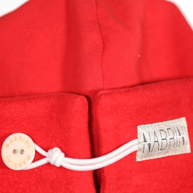 Close up of a red nautical themed beanie on a white background
