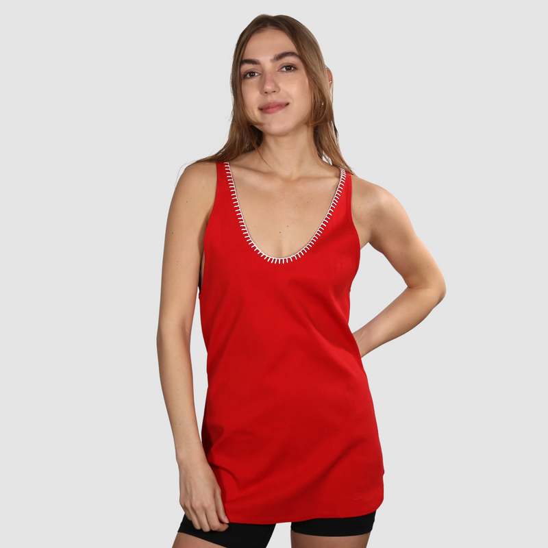 Woman wearing a red nautical themed tank top on a white background