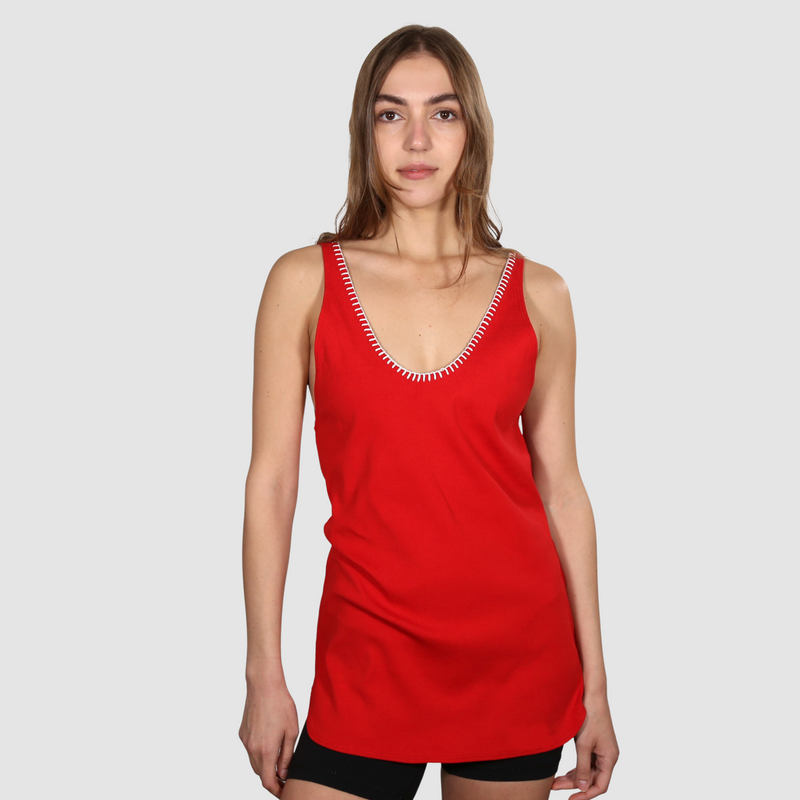 Woman wearing a red nautical themed tank top on a white background