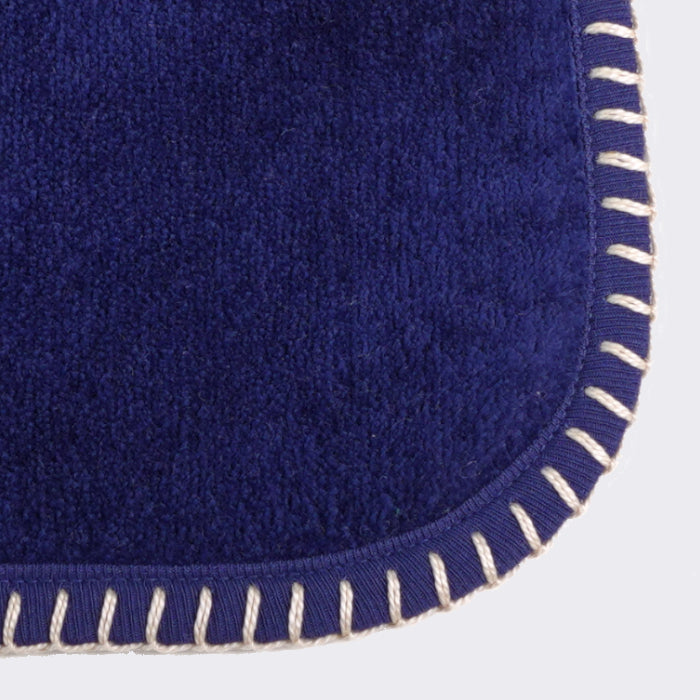 Close up of corner of a towel. Royal Blue towel with Champagne color edge stiting.