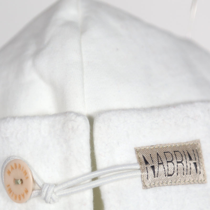 Close up of a white nautical themed beanie
