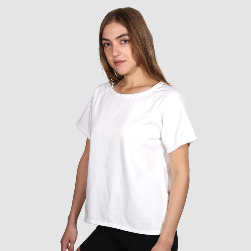 Woman wearing a white nautical themed crew neck T Shirt on a white background