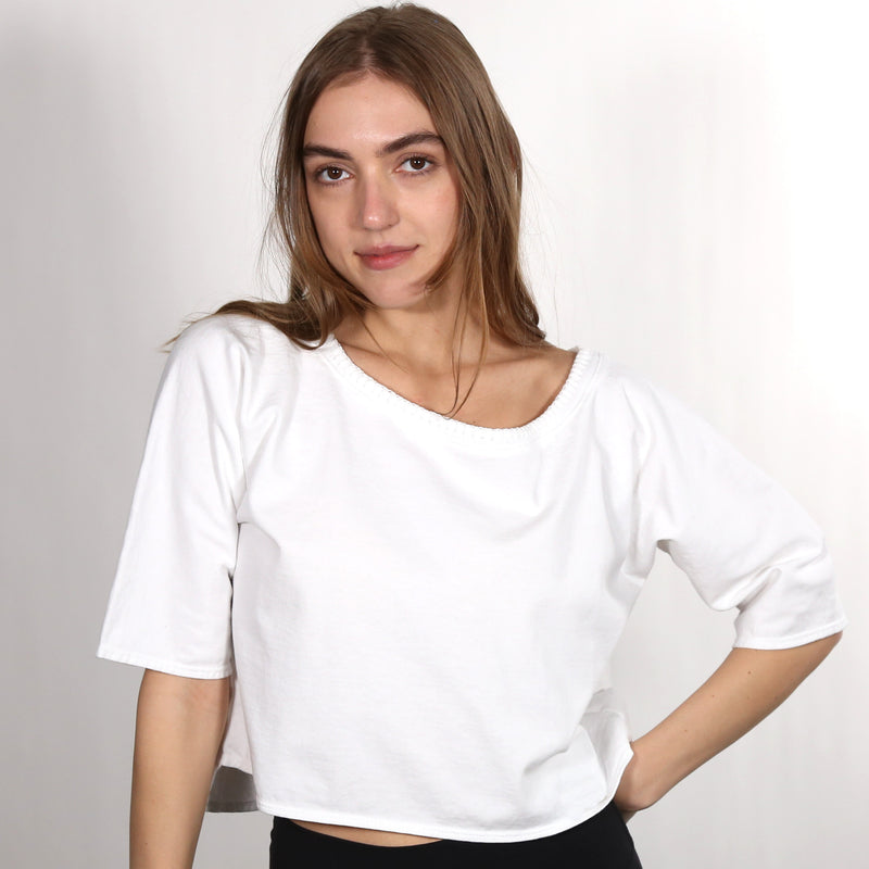 Woman wearing a white wide neck nautical themed T Shirt on a white background