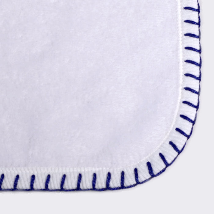 Close up of corner of a towel. White towel with soldier blue color edge stiting.